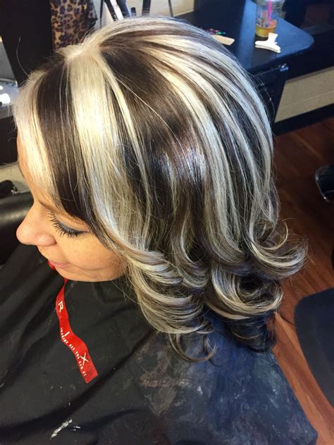 Layer up the gray like this chick by dyeing it on your upper or lower layers. . Platinum highlights on dark brown hair